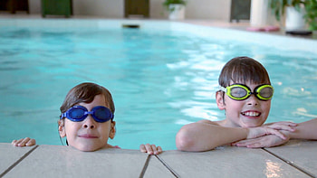 Two kids in swimming glasses stay on pool edge Stock Video Footage - VideoBlocks HD wallpaper