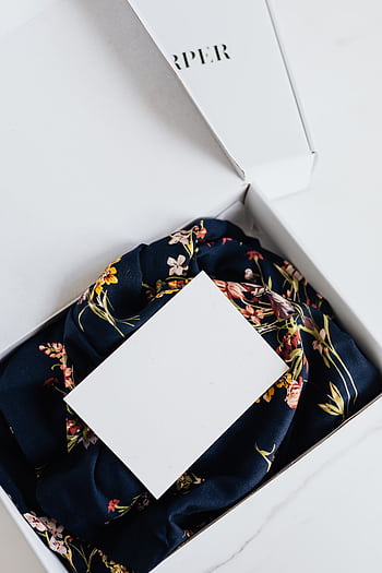 A stylish floral silk scarf elegantly presented in a luxury gift box with copy space. HD phone wallpaper