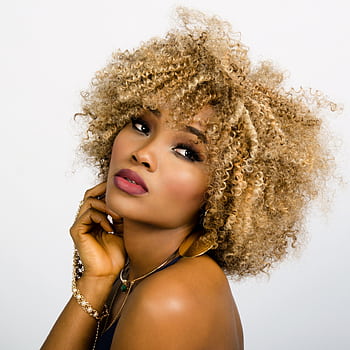 Elegant portrait of a woman with golden curly hair, showcasing beauty and confidence. HD phone wallpaper