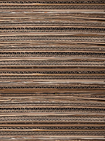 Close-up texture of stacked cardboard for recycling or crafting. Ideal for background use. HD phone wallpaper