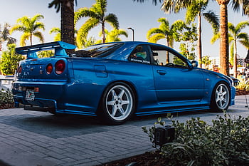 Stunning blue Nissan GT-R R34 showcased at a car event in Tampa, Florida. HD wallpaper