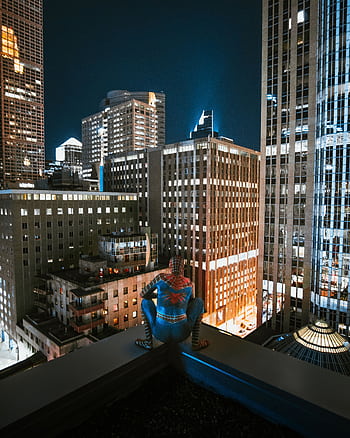 Spider-Man perched on a rooftop, overlooking a brightly lit city skyline at night, capturing the urban vibrancy. HD phone wallpaper