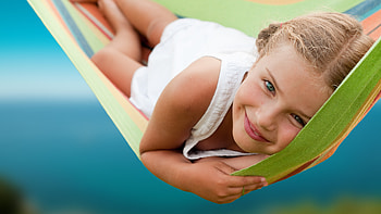 Smiley Cute Little Girl Is Lying Down On Swing Wearing White Dress Cute HD wallpaper