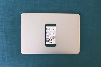 Flat lay of a smart on a laptop with social media on screen. HD wallpaper
