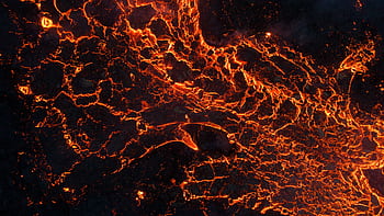 A captivating aerial shot of glowing lava showing natural volcanic activity. HD wallpaper