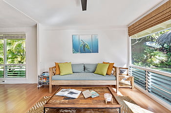 Stylish living room with natural light and nature view, perfect for relaxation. HD wallpaper