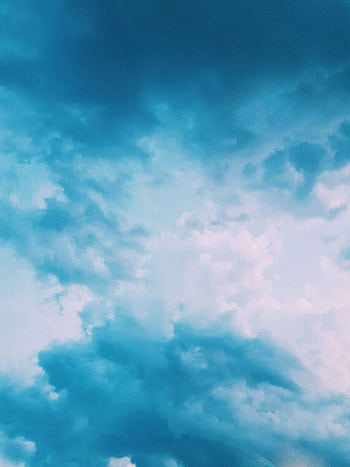A stunning blue sky filled with dynamic cloud patterns, creating a tranquil yet dramatic atmosphere. HD phone wallpaper