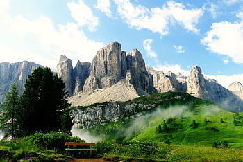 Idyllic mountain landscape with lush greenery and dramatic clouds. HD wallpaper