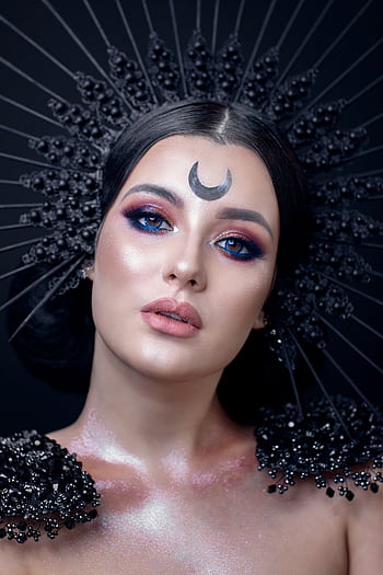 Captivating studio portrait of a woman with artistic crescent makeup and glamorous accessories. HD phone wallpaper