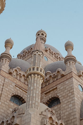 A beautifully detailed mosque with intricate Islamic architectural design captured at dusk. HD phone wallpaper