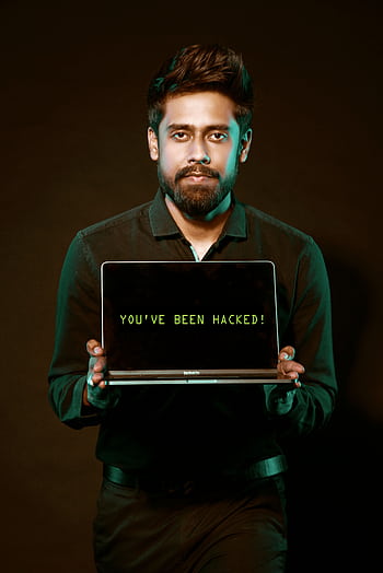 A man showing a laptop with a 'You've been hacked' message, symbolizing cyber security threats. HD phone wallpaper