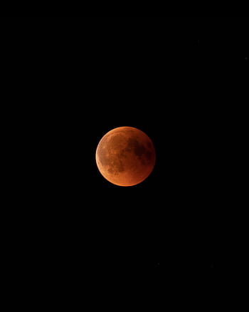 Captivating view of a blood moon during a lunar eclipse at night, showcasing the moon's surface features. HD phone wallpaper