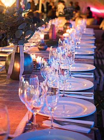 A beautifully set dinner table with candles and glassware, perfect for elegant events. HD phone wallpaper