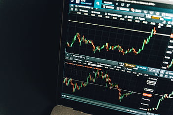 Close-up of a live cryptocurrency trading chart screen displaying dynamic market trends and analysis. HD wallpaper