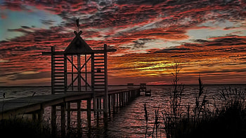 closed gates on pier at sunset, sea, gates, clouds, pier, sunset HD wallpaper