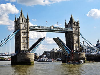 Iconic Tower Bridge in London with raised bascules over the River Thames on a sunny day. HD wallpaper