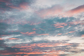 Vibrant sky with pink and blue clouds at sunset, perfect for backgrounds. HD wallpaper