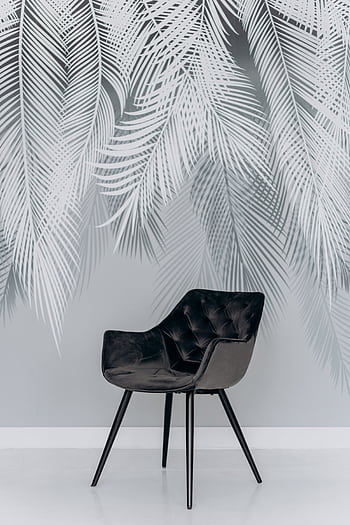 Stylish black chair featured against a grey palm leaf patterned wall, exuding contemporary elegance. HD phone wallpaper