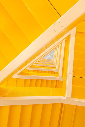 A vibrant yellow modern staircase showcasing minimalist geometric design with a unique perspective. HD phone wallpaper