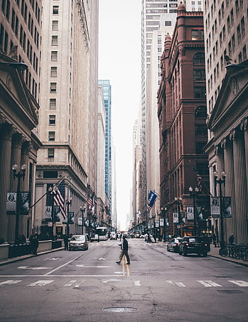 Classic view of a pedestrian crossing a bustling Chicago street lined with skyscrapers. HD phone wallpaper