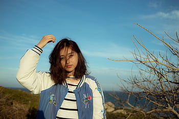 Portrait of a young woman enjoying the outdoors in Đắk Ya, Gia Lai, Vietnam under a clear blue sky. HD wallpaper