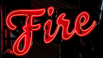 A striking red neon sign spelling 'Fire' in a dark setting, ideal for urban themes. HD wallpaper