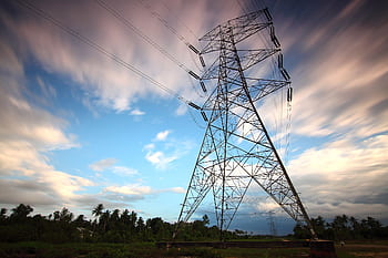 Stunning view of a towering power line against a vibrant sky, showcasing energy infrastructure in nature. HD wallpaper