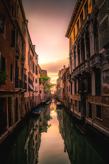Captivating sunset view reflected on a serene Venetian canal amidst historic architecture. HD phone wallpaper