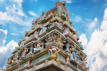 Vibrant gopuram of a Hindu temple in Salem, India, showcasing intricate designs under a blue sky. HD wallpaper