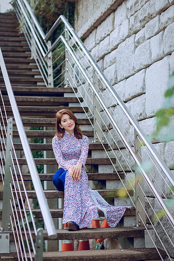 Elegant woman in floral dress posing on outdoor staircase. HD phone wallpaper