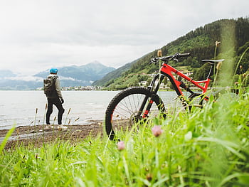 Cyclist overlooking Zell am See in Salzburg, Austria. Perfect for adventure and travel themes. HD wallpaper