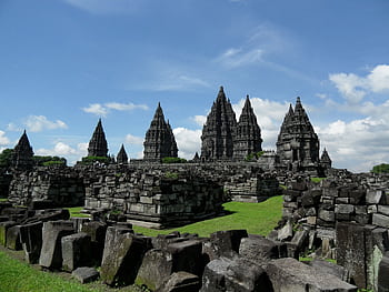 Explore the ancient Prambanan Temple in Java, Indonesia, with stunning stone architecture against a clear blue sky. HD wallpaper