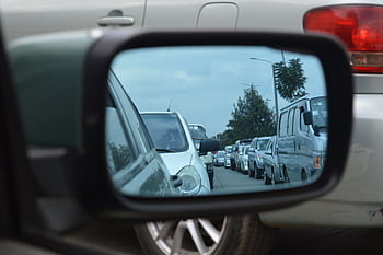 Reflection of a busy traffic jam in Nairobi captured through a car's side mirror. HD wallpaper