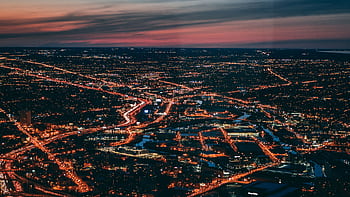 Captivating aerial cityscape of Chicago with illuminated streets and a vibrant dusk sky. HD wallpaper