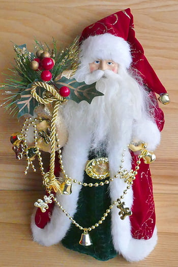 Festive Santa Claus decoration with gold accents for holiday celebration. HD phone wallpaper