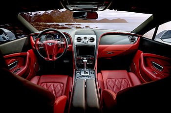 Red leather luxury sports car interior with mountain backdrop outside the window. HD wallpaper