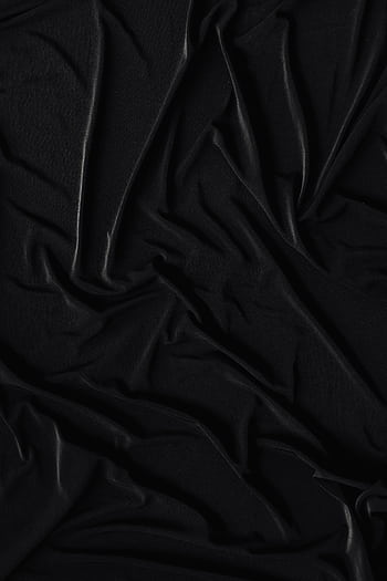 A detailed shot of a crumpled black fabric, showcasing its smooth and wrinkled texture in a monochromatic tone. HD phone wallpaper