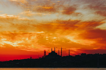 Dramatic silhouette of a mosque against a vibrant sunset sky in Istanbul, Turkey. HD wallpaper