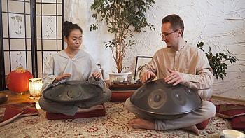 Man and woman playing hang drums, stock video, Musical duet, Harmonic melodies HD wallpaper