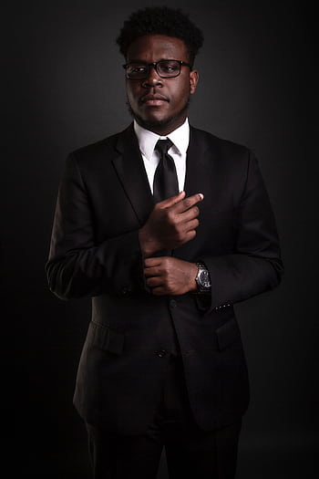 Stylish African American man in a black suit, looking confident and professional against a dark background. HD phone wallpaper