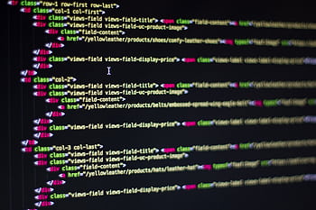 Detailed close-up of HTML code on a computer monitor, showcasing web development. HD wallpaper