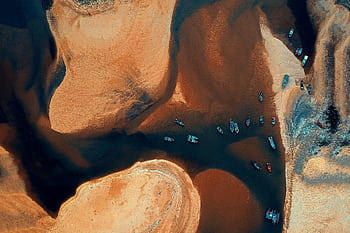 Stunning aerial view of vibrant boats on Kemasik river, Malaysia. Ideal for travel visuals. HD wallpaper