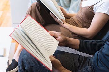 Two students reading books indoors, focused on learning and knowledge. HD wallpaper