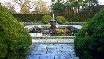 Discover serenity in a beautifully manicured garden with a central fountain, offering a peaceful retreat in the UK. HD wallpaper