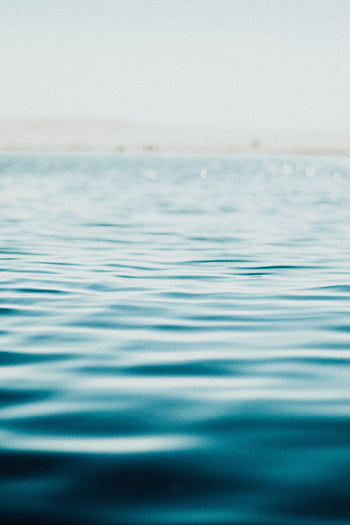 Serene ocean surface captured in soft focus, evoking calm and tranquility. HD phone wallpaper