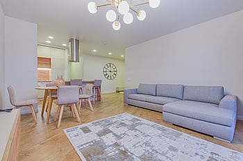 Spacious contemporary living room featuring stylish furniture and elegant lighting. HD wallpaper