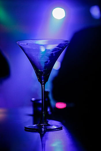 A crystal martini glass glows under vibrant nightclub lighting. HD phone wallpaper