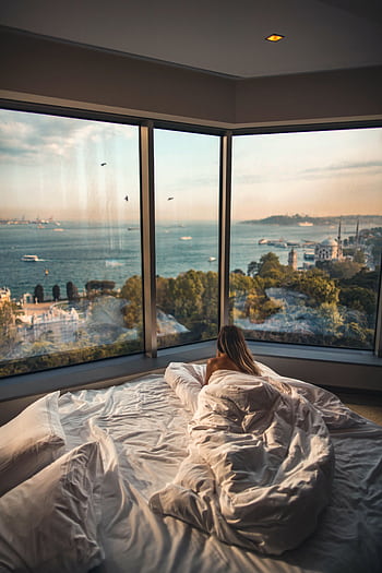 Relaxing in a cozy hotel room with stunning views of the Bosphorus at sunset in Istanbul, Turkey. HD phone wallpaper