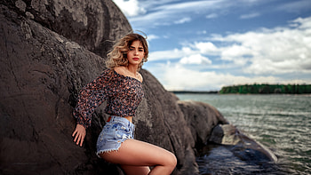 Unknown Model, sea, model, blonde, gorgeous, beautiful, rocks, beach, woman, clouds, water, ocean HD wallpaper