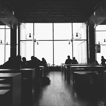 Black and white silhouette of people sitting and chatting in a modern cafeteria. HD phone wallpaper